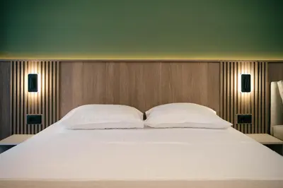 a large white bed with two pillows on it at Solea Apartments in Ulcinj