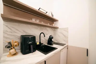 a kitchen with a black coffee maker on a counter at Solea Apartments in Ulcinj