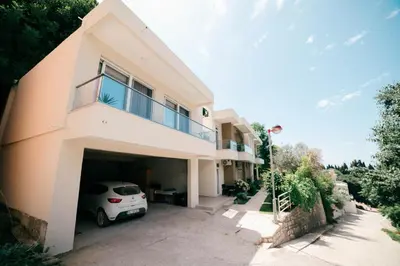 a house with a car parked in the garage at Solea Apartments in Ulcinj