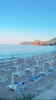 a bunch of chairs and chairs on a beach at Quattro Rocce Apartments Zelen in Sutomore