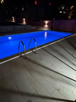 a swimming pool at night with blue water at Blue Escape in Danilovgrad