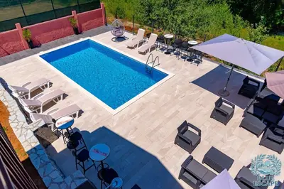 an overhead view of a swimming pool with lounge chairs at Blue Escape in Danilovgrad