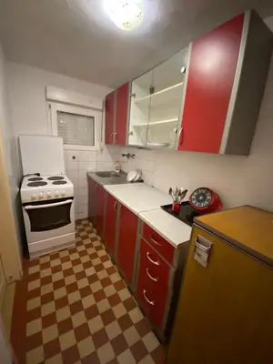 a kitchen with red cabinets and a white stove at Lana in Cetinje