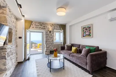 a living room with a couch and a table at Luxury Villa Pjetra