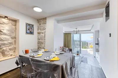 a dining room with a table and chairs at Luxury Villa Pjetra