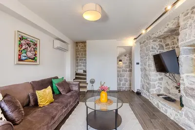 a living room with a couch and a tv at Luxury Villa Pjetra