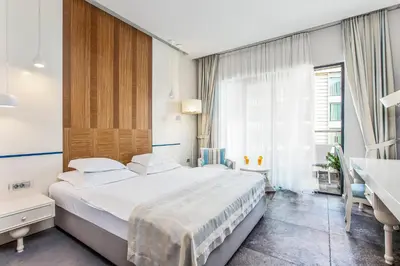 a bedroom with a large bed and a window at Hotel Bracera in Budva