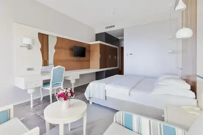 a hotel room with a bed and a desk at Hotel Bracera in Budva