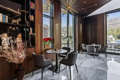 a restaurant with tables and chairs and windows at Hotel Bracera in Budva