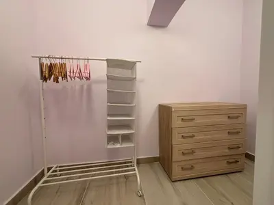 a closet with a wooden dresser and a shelf at Vuko i Magdalena Midzor in Petrovac na Moru