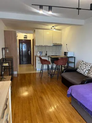 a living room with a couch and a table and a kitchen at PriSMi PRZNO in Pržno