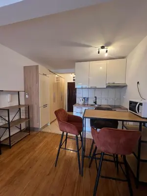 a kitchen with a table and chairs in a room at PriSMi PRZNO in Pržno