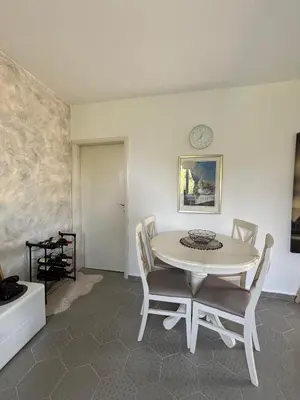 a dining room with a white table and chairs at Deaf Valley Apartment 2 in Reljići