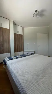 a bedroom with a large bed with a ceiling at One bedroom apartment with sea view Becici in Becici