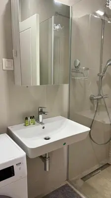 a bathroom with a white sink and a shower at One bedroom apartment with sea view Becici in Becici