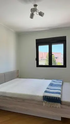 a bedroom with a bed and a window at One bedroom apartment with sea view Becici in Becici