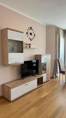 a living room with a clock on the wall at One bedroom apartment with sea view Becici in Becici