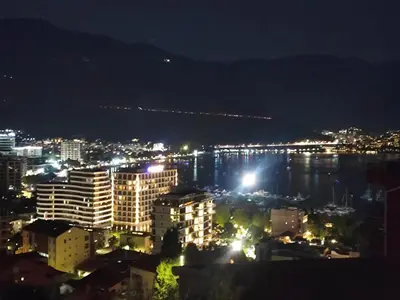 a view of a city at night with lights at Apartman braco in Budva