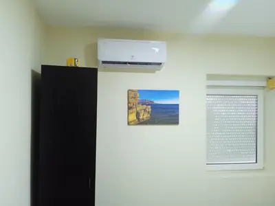 a room with a black cabinet and a window at Apartman braco in Budva