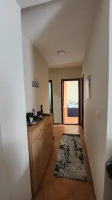 an empty room with a kitchen with a large window at Apartman braco in Budva
