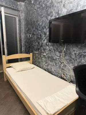 a bed with a flat screen tv on a wall at Martina 1 in Budva