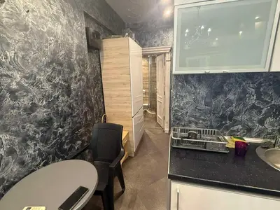 a small kitchen with a sink and a table at Martina 1 in Budva