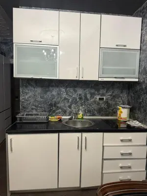 a kitchen with white cabinets and a sink at Martina 1 in Budva
