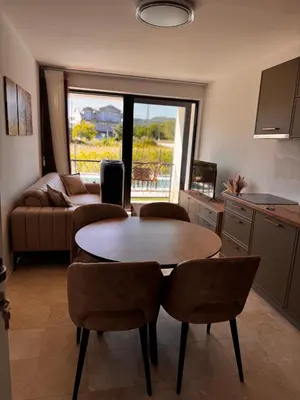 a kitchen and living room with a table and chairs at Villa Anastasija in Kotor