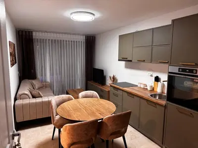 a kitchen and living room with a table and a couch at Villa Anastasija in Kotor