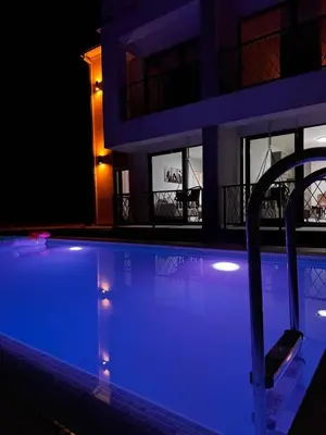 a house with a swimming pool at night at Villa Anastasija in Kotor
