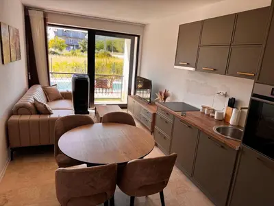 a kitchen and living room with a table and chairs at Villa Anastasija in Kotor