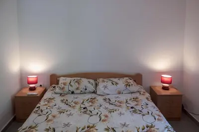 a bedroom with a bed with two lamps on tables at Barona Seaview Penthouse Kotor Bay in Kotor
