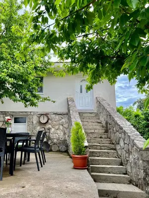 a stone stairway leading to a house with a table and chairs at Nina House Charming Apartment, Prevlaka in Prevlaka