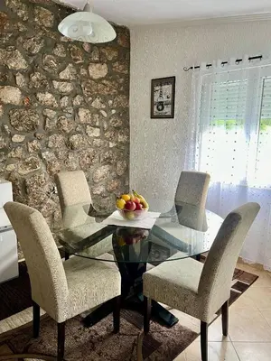 a dining room with a glass table and chairs at Nina House Charming Apartment, Prevlaka in Prevlaka