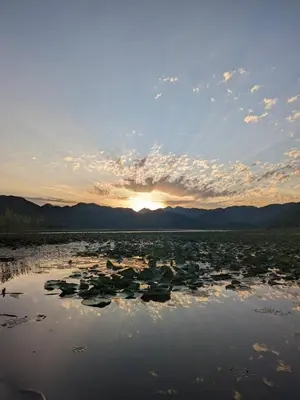 a large body of water with a sunset in the background at Nina House Charming Apartment, Prevlaka in Prevlaka