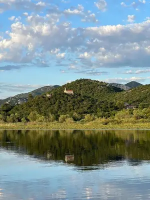 a view of a lake with a house on a hill at Nina House Charming Apartment, Prevlaka in Prevlaka