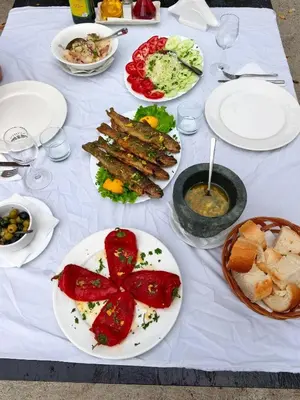 a white table with plates of food on it at Nina House Charming Apartment, Prevlaka in Prevlaka