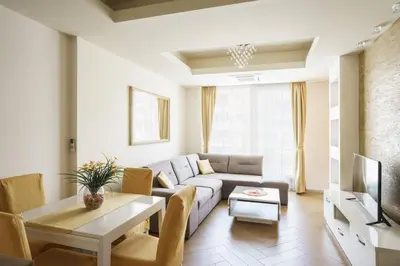 a living room with a couch and a table at Cozy City Center Studio in Babalonija