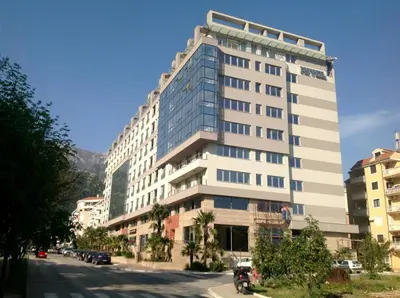a tall white building on the side of a street at Cozy City Center Studio in Babalonija