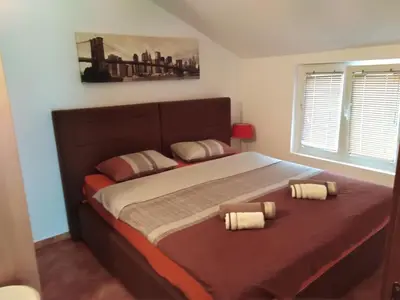 a bedroom with a large bed with two pillows at Apartments Martiva in Kotor