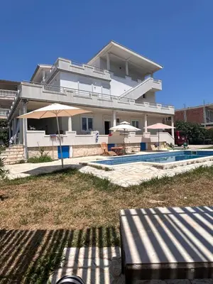 a large house with a swimming pool and a building at Villa Alidah Avkoppling med utsikt, pool och fruktträd in Bar