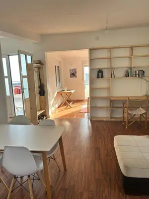 a living room with a white table and chairs at Villa Alidah Avkoppling med utsikt, pool och fruktträd in Bar