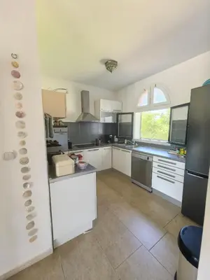 a large kitchen with white cabinets and a large window at Villa With Swimming Pool in Ulcinj