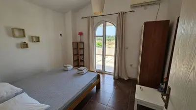 a bedroom with a bed and a large window at Villa With Swimming Pool in Ulcinj