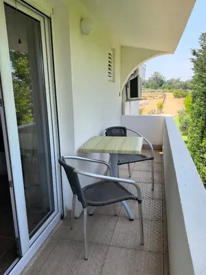 a balcony with a table and chairs on it at Villa With Swimming Pool in Ulcinj