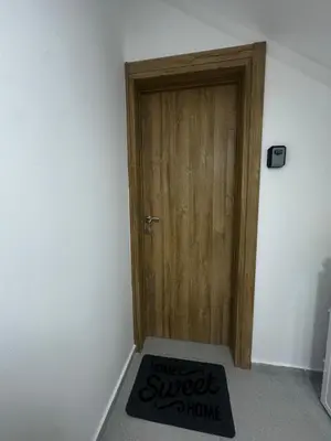 a door with a welcome mat in front of a room at Apartments ML in Kotor