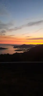 a view of a sunset over a body of water at House with pool and seaview in Kuljače