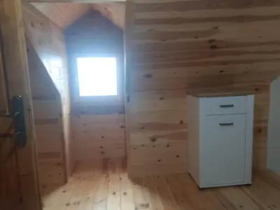 a room with wooden walls and a small window at House with pool and seaview in Kuljače