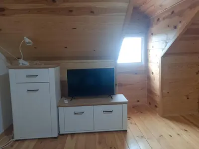 an attic room with a desk and a window at House with pool and seaview in Kuljače