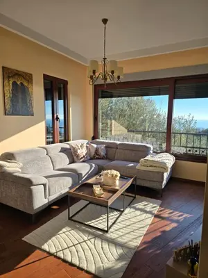 a living room with a couch and a table at Vista Blue Villa in Budva